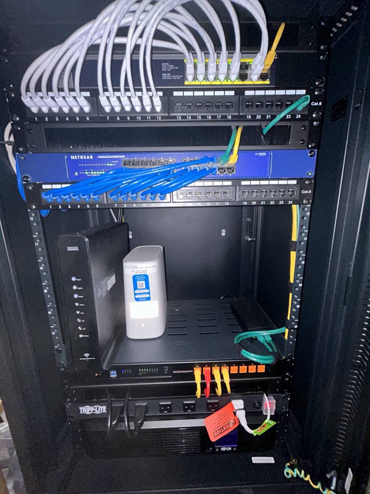 Wall-mounted network cabinet with neatly routed cabling